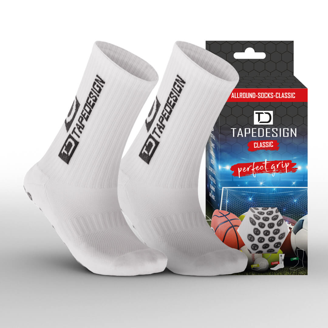 A pair of white athletic socks with branding text, displayed alongside its packaging which has sports imagery and text 'TAPEDESIGN CLASSIC'.