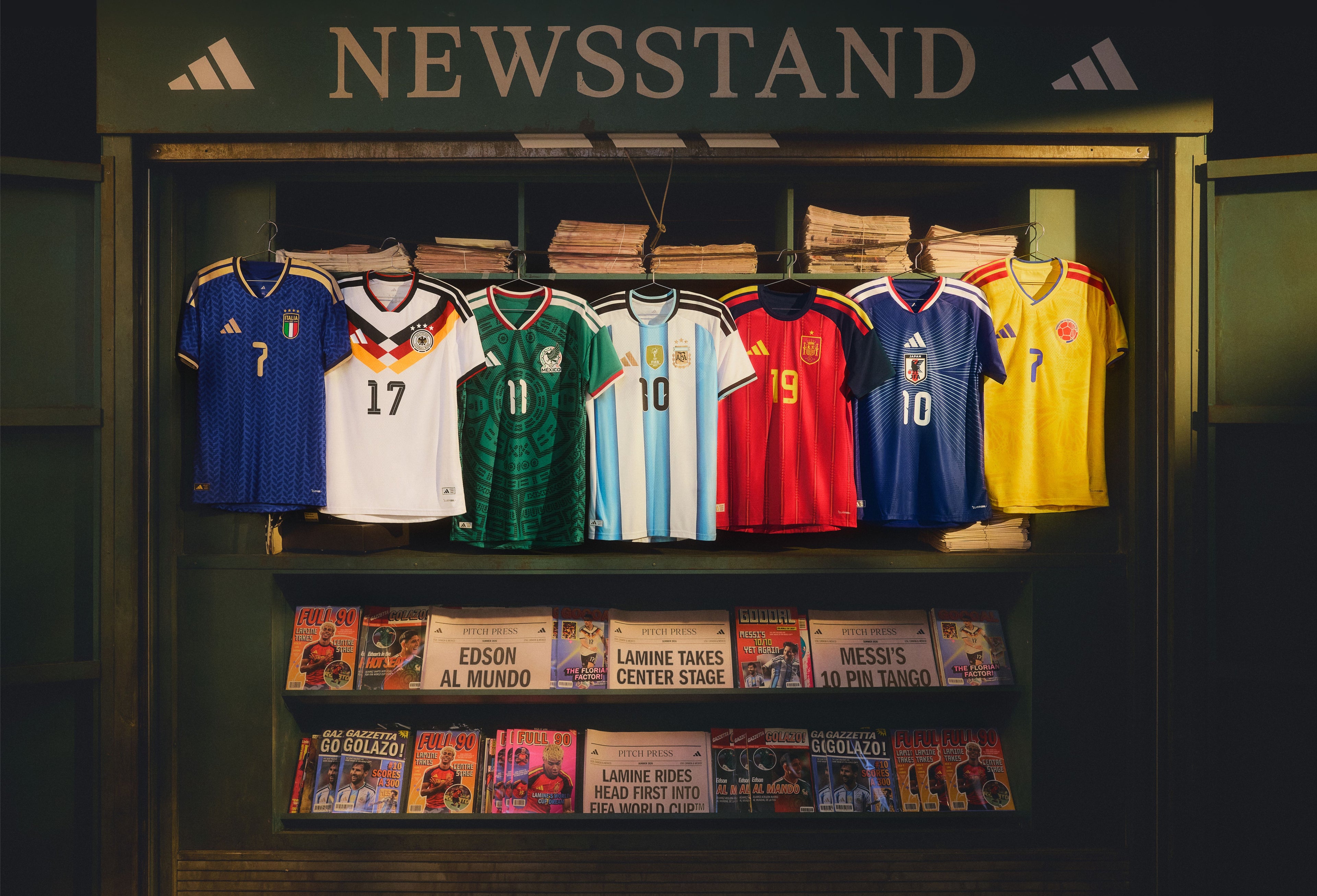 Display of soccer jerseys and magazines inside a newsstand with Adidas branding.