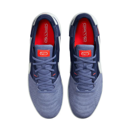 Pair of blue athletic shoes with red interior and visible brand logo on a white background