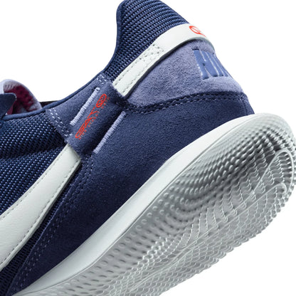 Navy blue sneaker with white sole on a white background