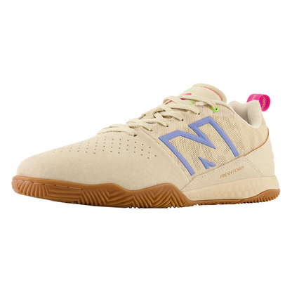 Beige athletic shoe with brown sole on a white background